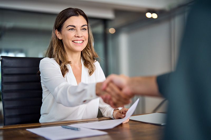 woman shaking hands with banker